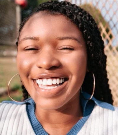Smiling woman with braided hair: Facevity · Glam