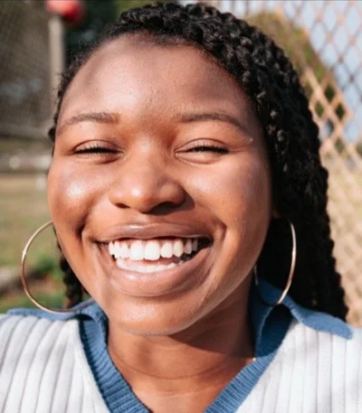 Smiling woman with braided hair: original